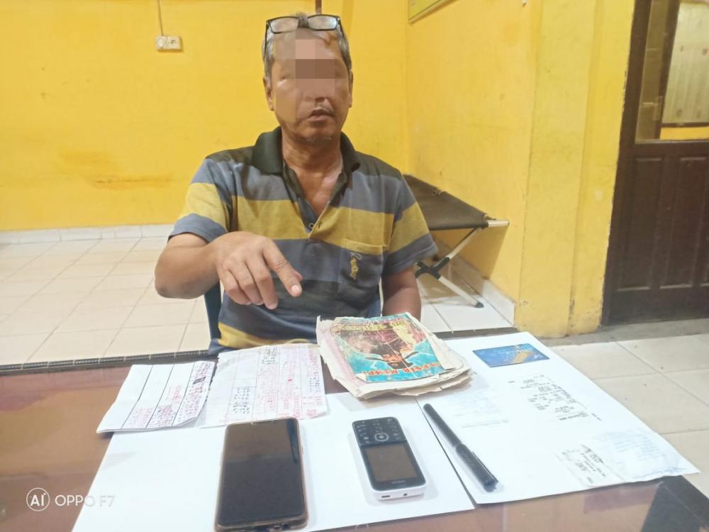 Opsnal Polsek Tapung Hulu Tangkap Penjual Nomor Togel Kim di Pasar Kasikan